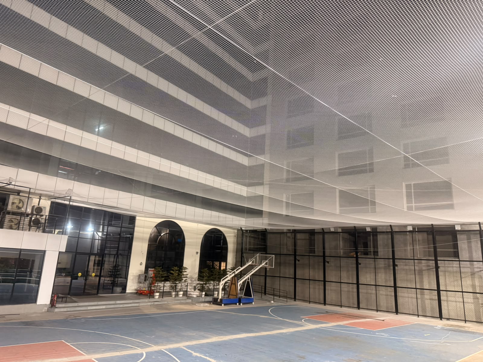 Overhead safety netting installed over a sports court