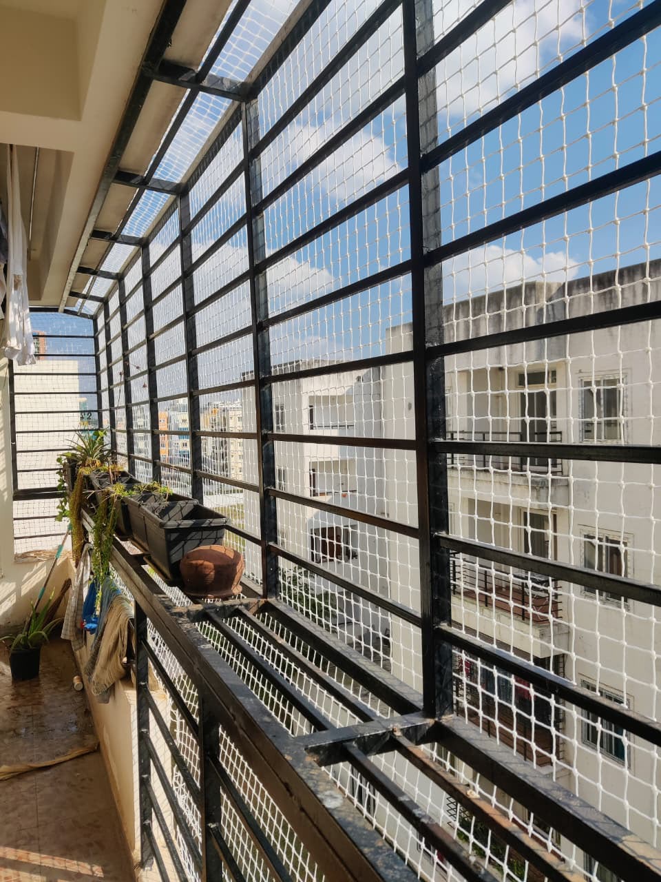 Balcony safety net fitted along an apartment railing in Bengaluru